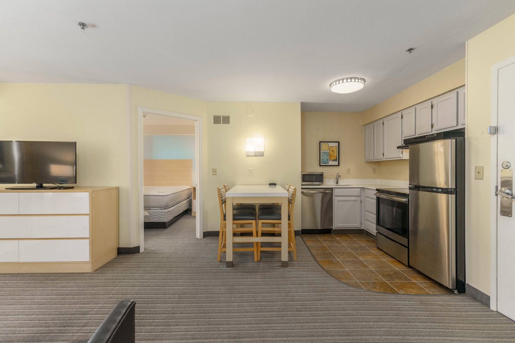 a kitchen and dining area in a hotel room